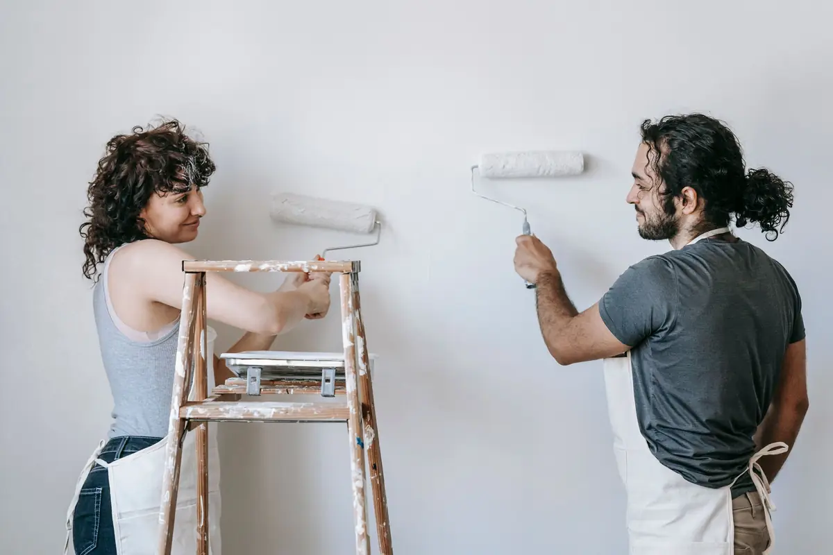 People painting a wall together — painting help in Little Rock